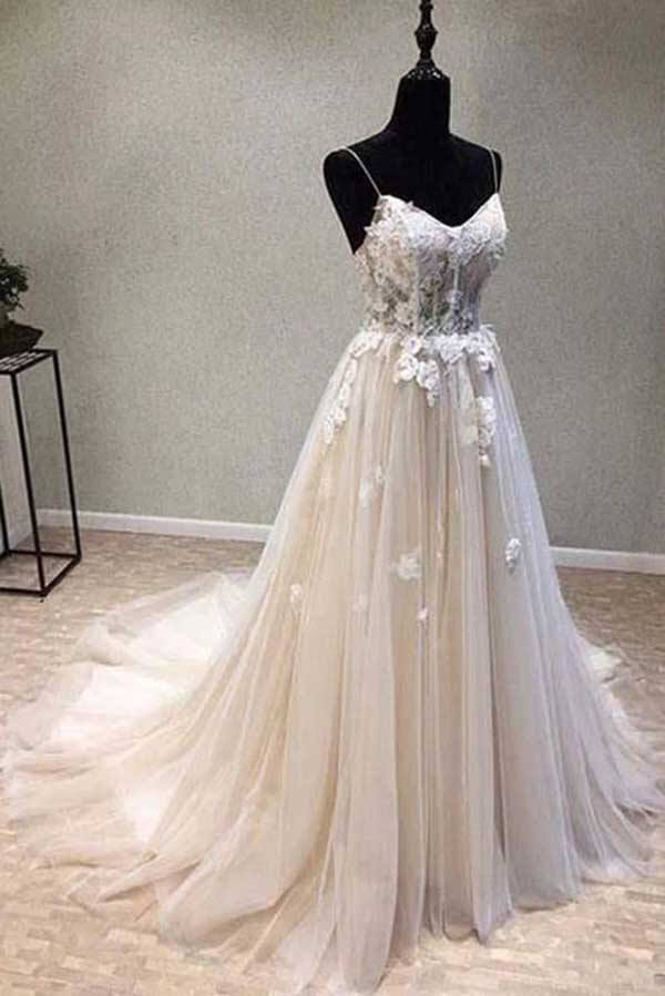 Close-up of intricate lace appliques on an elegant A-line bridal dress.