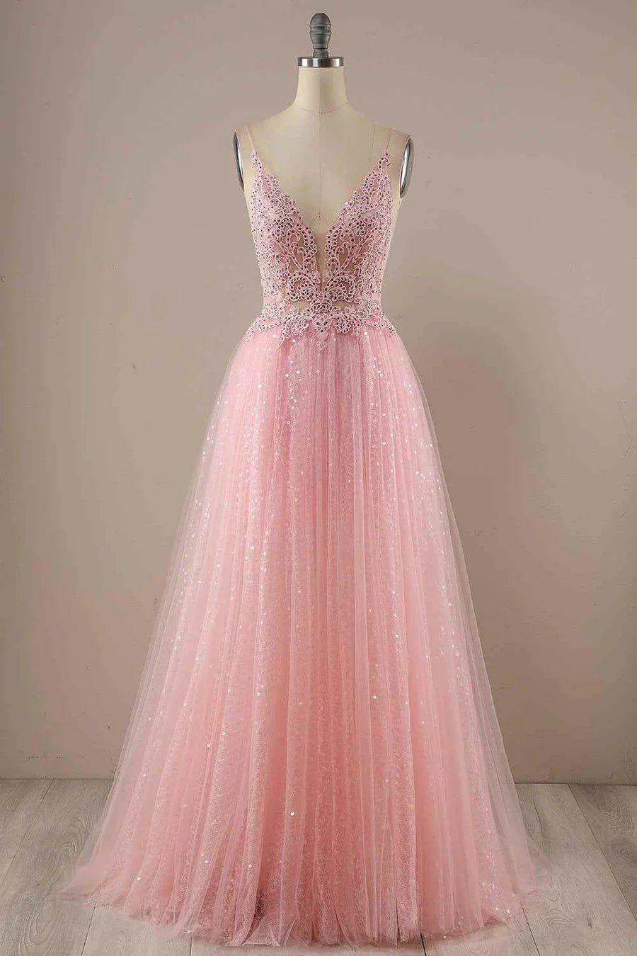 Model wearing a sparkly A-line V-neck long prom dress with tulle appliques.