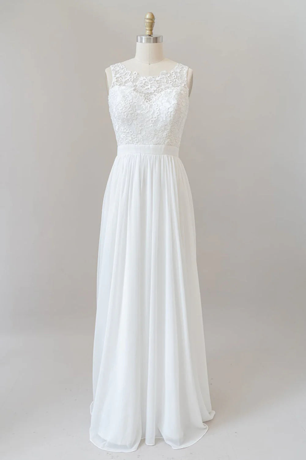 Bride wearing an A-line V-neck lace wedding dress with delicate straps.