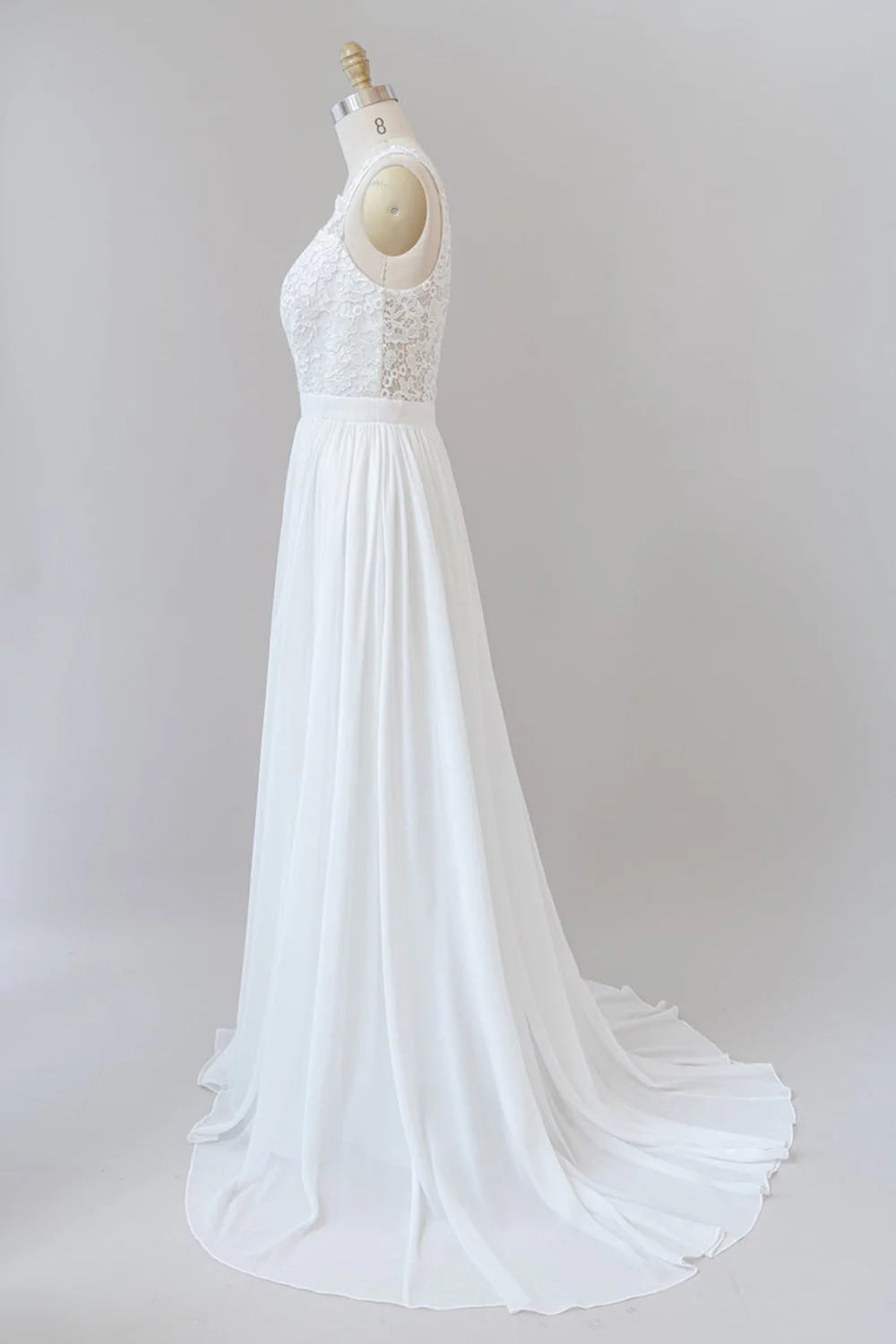 Back view of a bride in a lace A-line wedding dress with strap details.