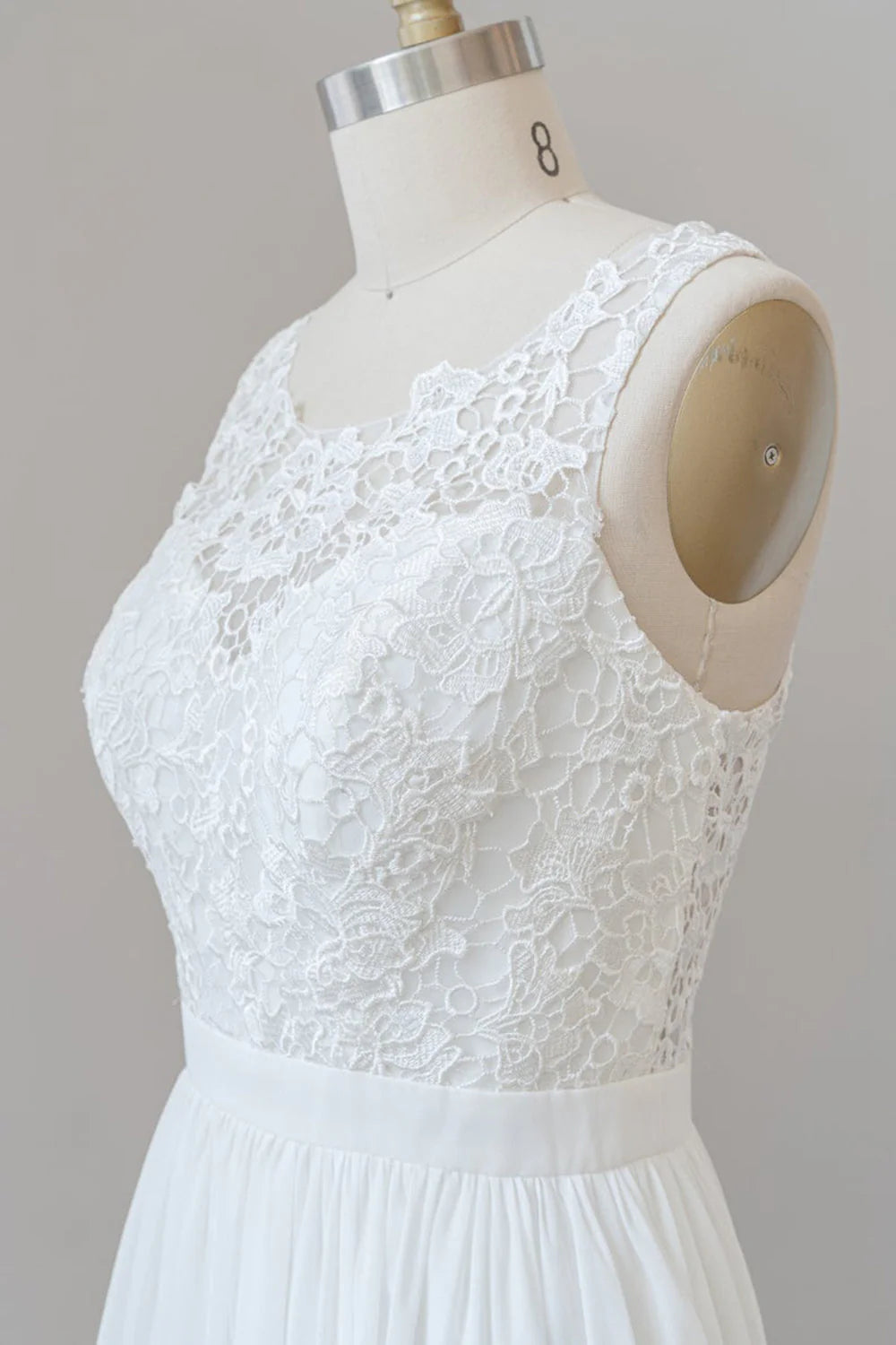 Side profile of a bride in a V-neck A-line wedding dress.