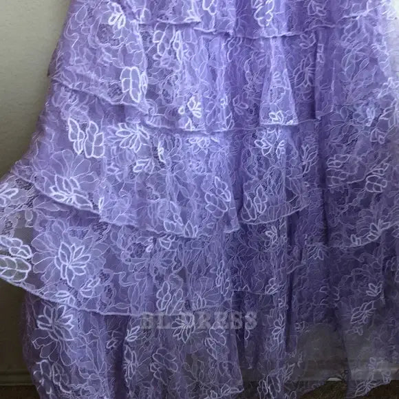 Side profile of the flowing lilac A-line evening gown.