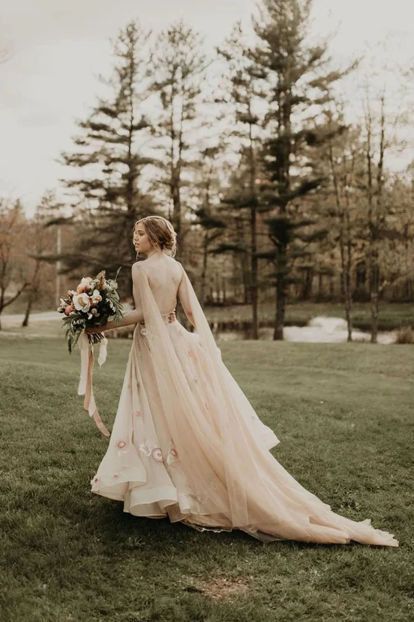 Full view of a bride wearing an A-line V-neck tulle wedding dress with colorful 3D flowers.