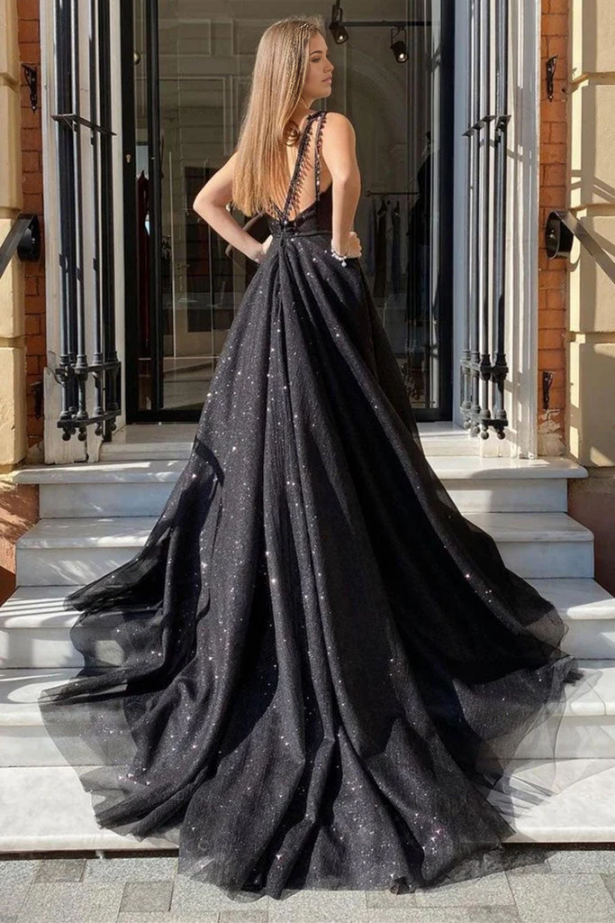 Side view of the black A-line prom dress, highlighting the flowing tulle skirt and high slit.