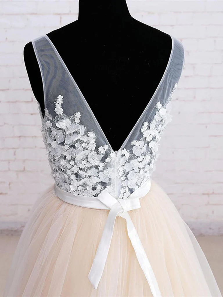 Close-up of floral embroidery on the tulle fabric of the ball gown.
