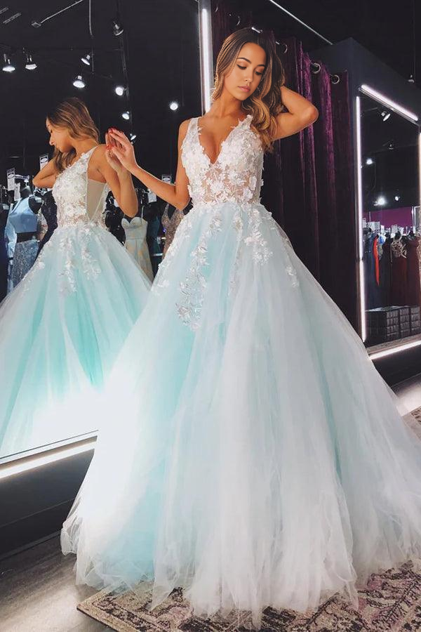 Woman wearing an elegant A-line V-neck tulle lace floral long prom dress.