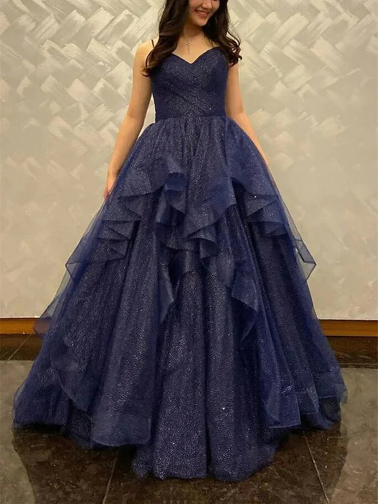 Woman wearing an elegant A-line V-neck tulle long prom dress.