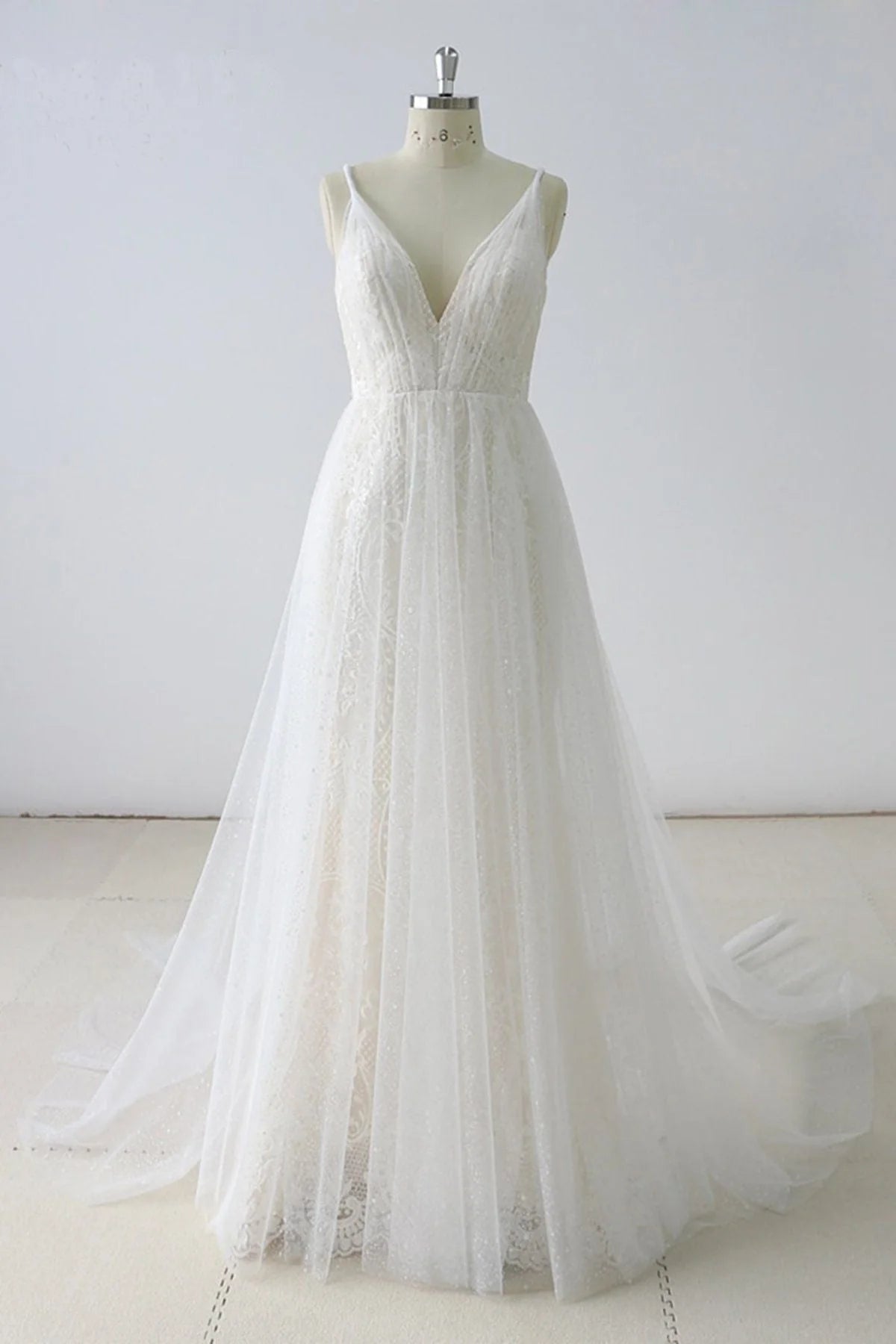 Elegant A-line V-neck tulle wedding dress, full length view.