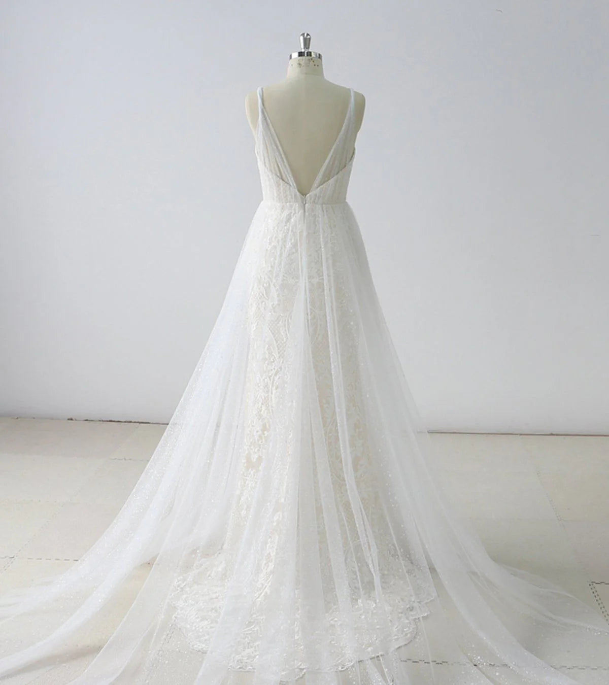 A-line V-neck tulle wedding dress, showing delicate fabric detail.