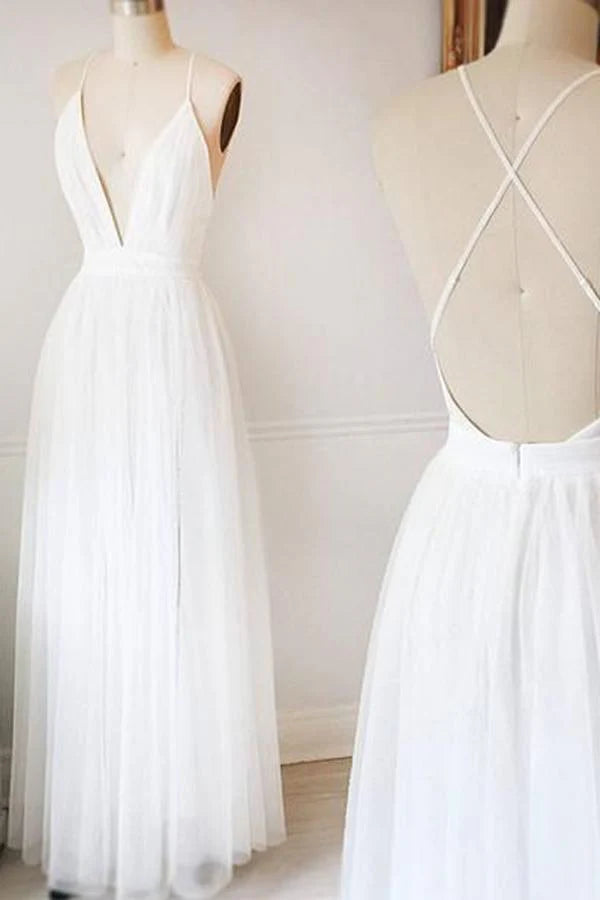 Woman wearing an elegant A-line V-neck tulle wedding or prom dress.