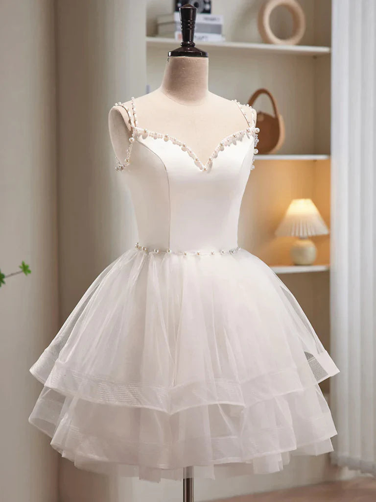 Close-up of the V-neckline and tulle fabric on the dress.