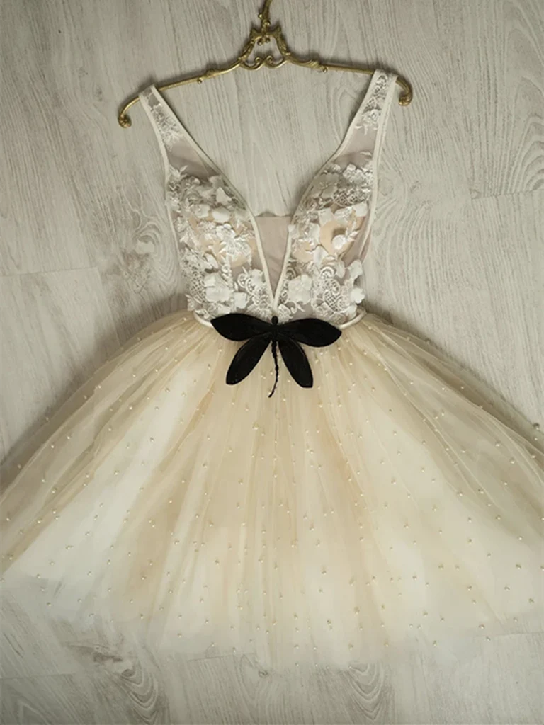 Woman wearing an elegant A-line V-neck short tulle dress.