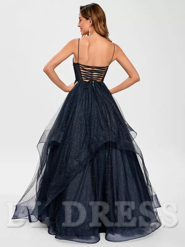 Back view of a woman in a sleeveless A-line tulle evening gown.