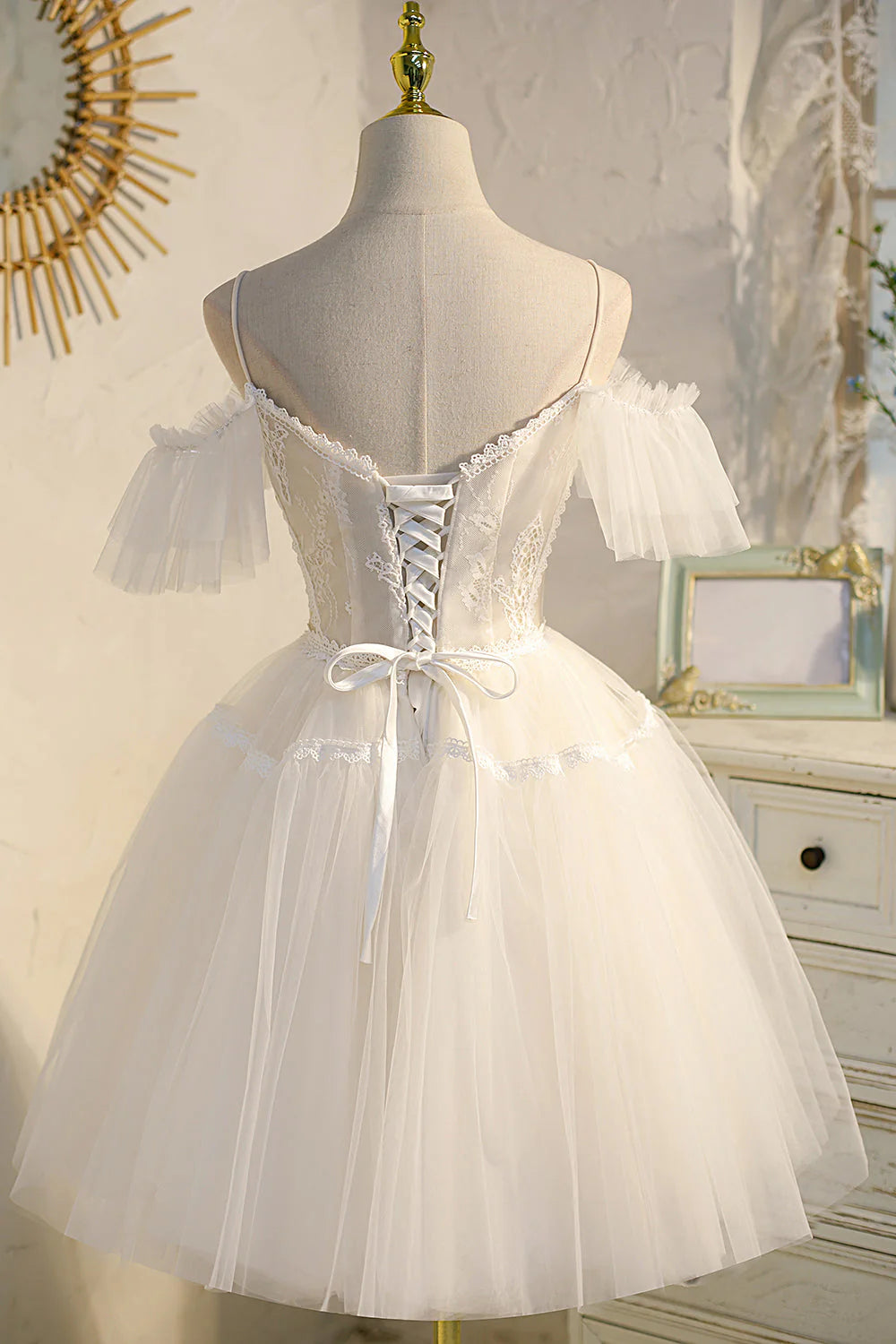 Back view of the A-line tulle dress, showing the delicate spaghetti straps.