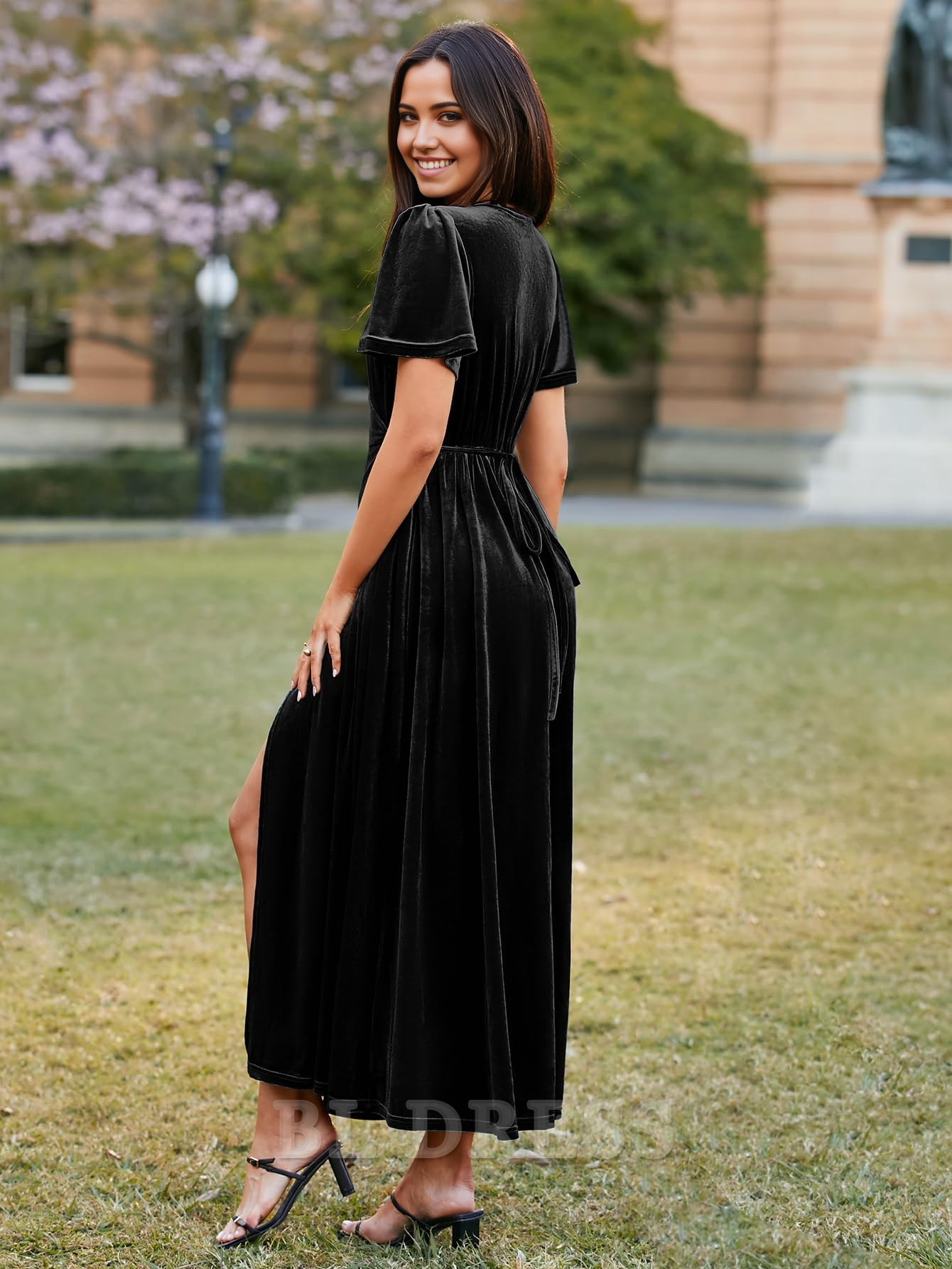 Close-up of the V-neckline and bell sleeve detail on a velvet dress.