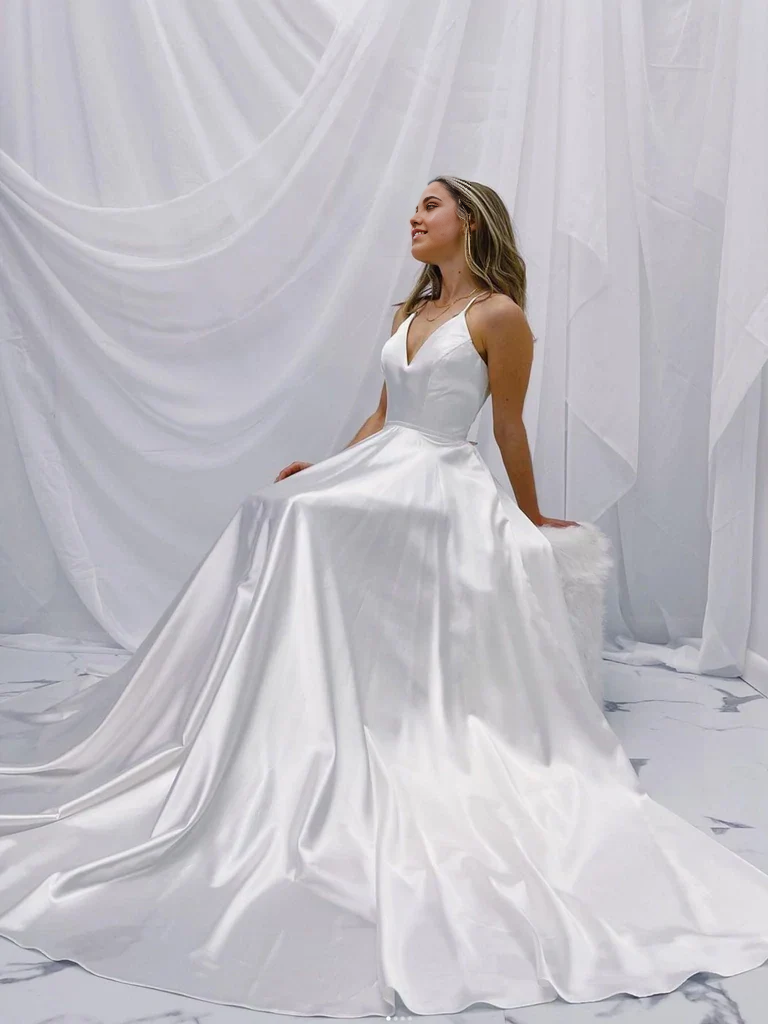 Model wearing an elegant A-line V-neck white satin long wedding dress.