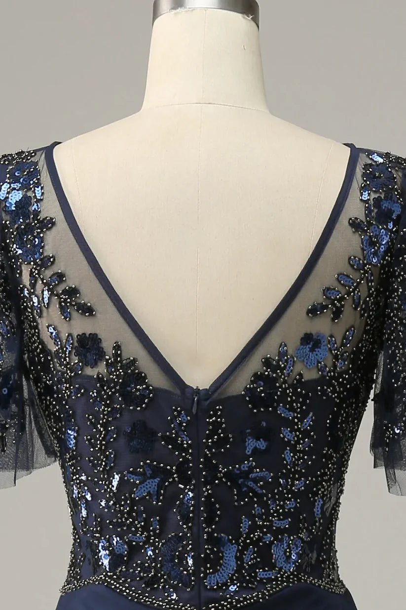 Detailed view of the V-neckline and bodice of the sequin applique dress.