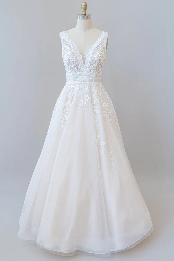 Elegant A-line V-neck wedding dress with lace appliques and tulle skirt.