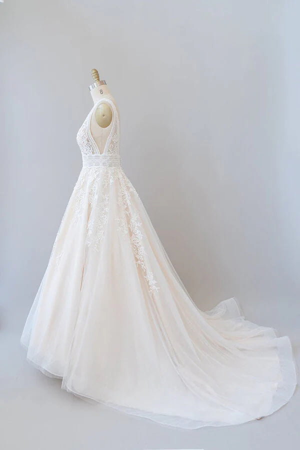 Close-up of delicate lace appliques on the V-neck wedding dress.