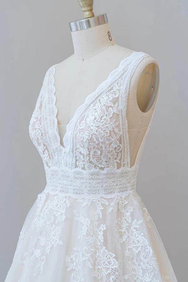 Side profile of the long A-line wedding dress with flowing tulle.