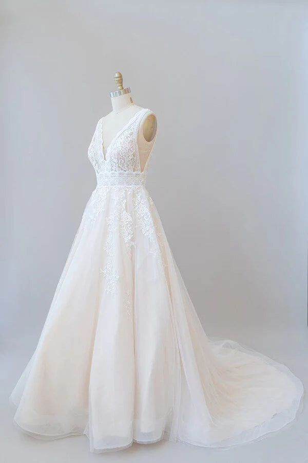 Full length view of the elegant bridal gown with V-neck and appliques.