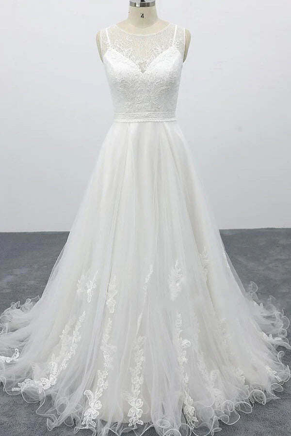 Bride wearing an A-line backless wedding dress with appliques.
