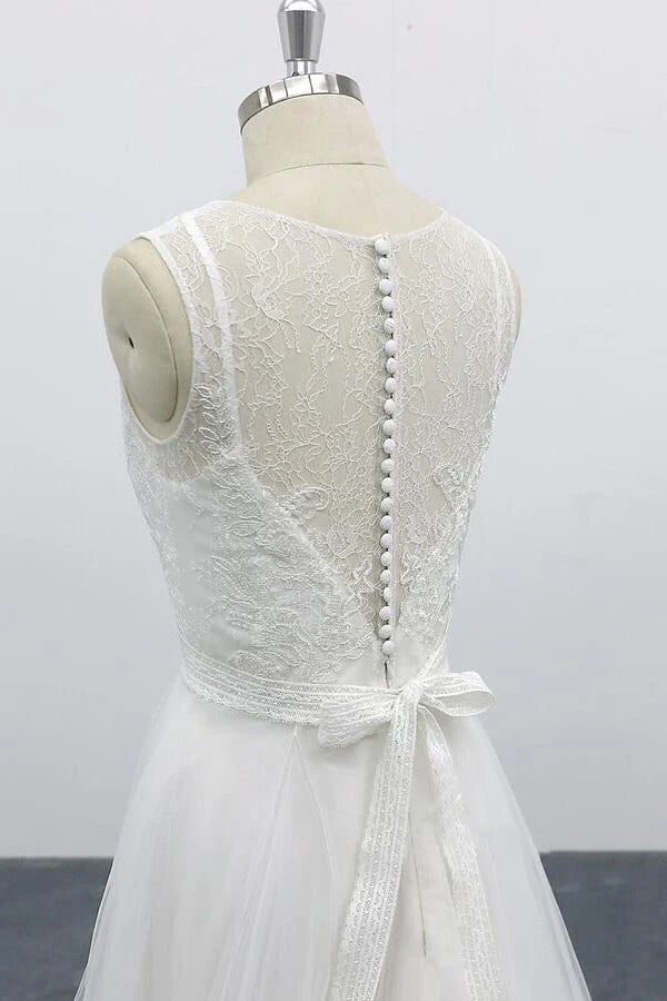 Close-up of the backless design and appliques on a wedding dress.