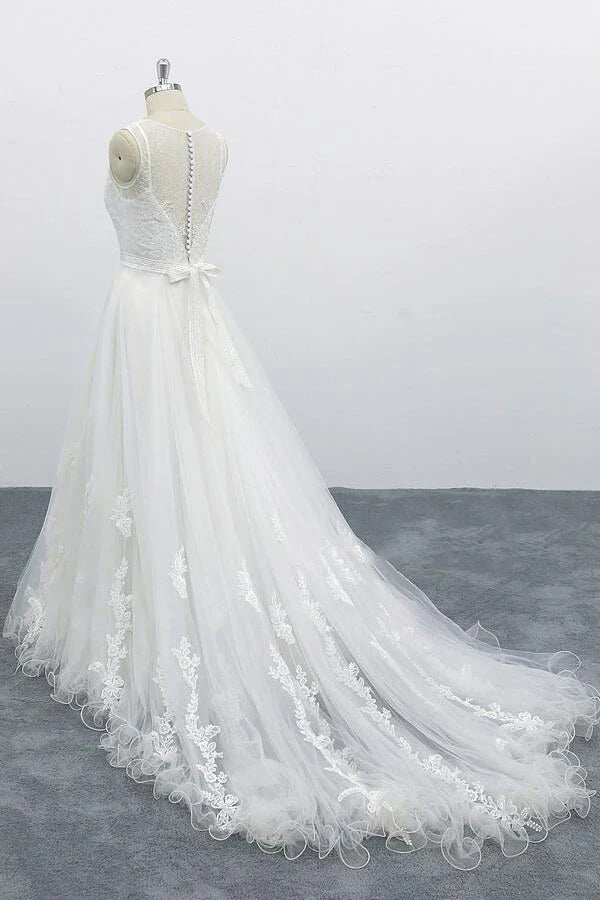 Full view of a bride in a long tulle A-line wedding dress.