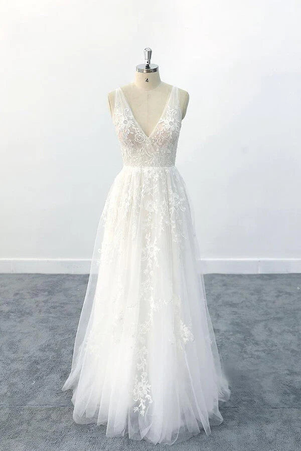 Elegant A-line V-neck wedding dress with appliques and flowing tulle.