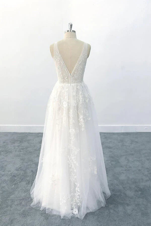 Back view of a bride wearing a backless A-line wedding gown.