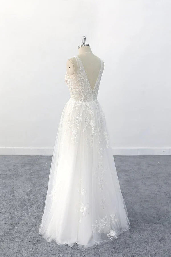 Close-up of delicate appliques on a V-neck tulle wedding dress.