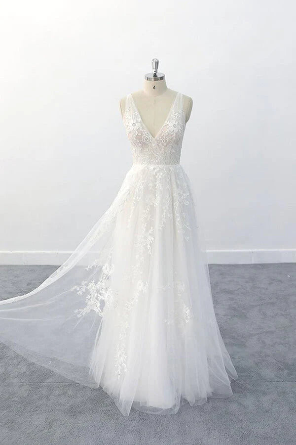 Side profile of an A-line bridal gown with a long train.