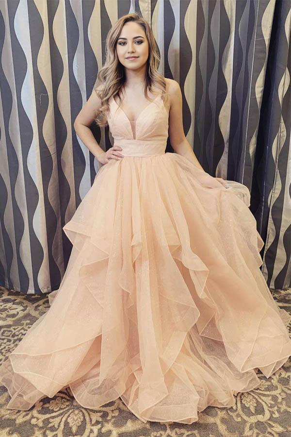 Champagne long formal dress with V-neck, delicate straps, and flowing ruffles.