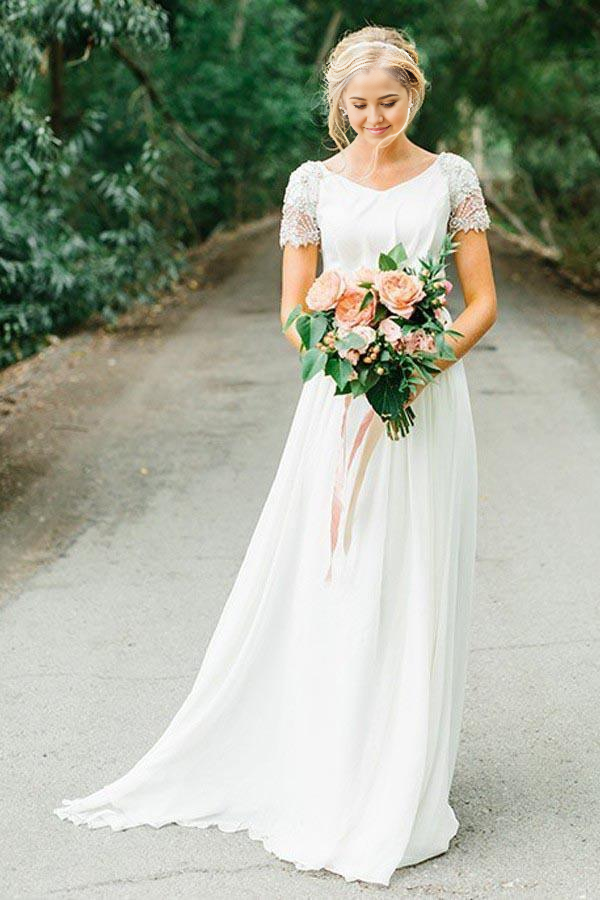 Model wearing an A-line V-neck chiffon wedding dress with delicate beadings.