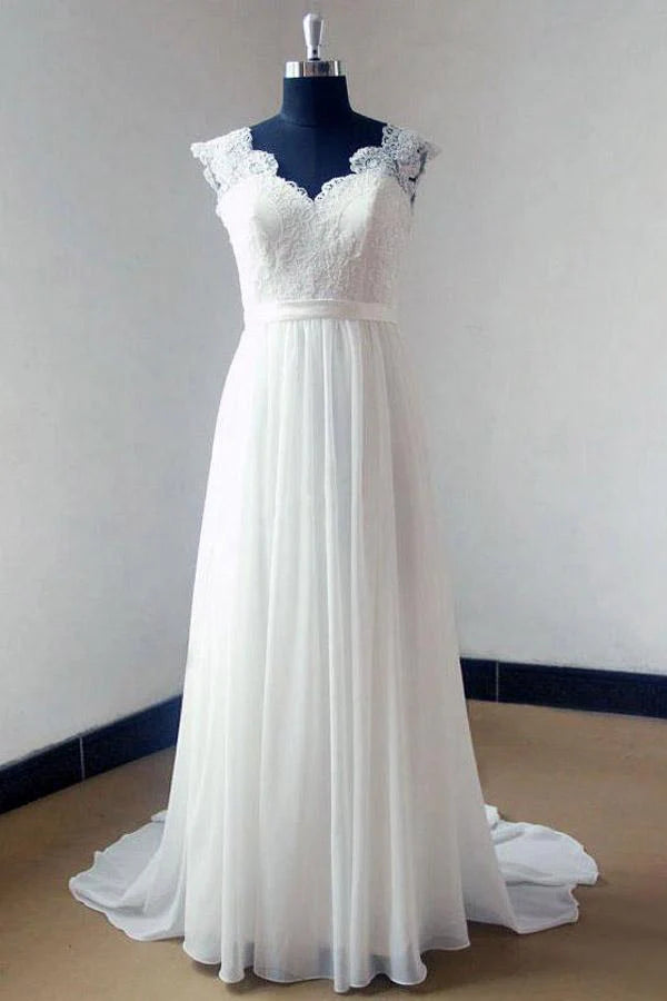 Elegant A-line chiffon lace V-neck wedding dress with sweep train on a model.