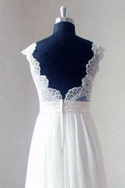 Close-up of the lace V-neck bodice and flowing chiffon skirt of the wedding dress.