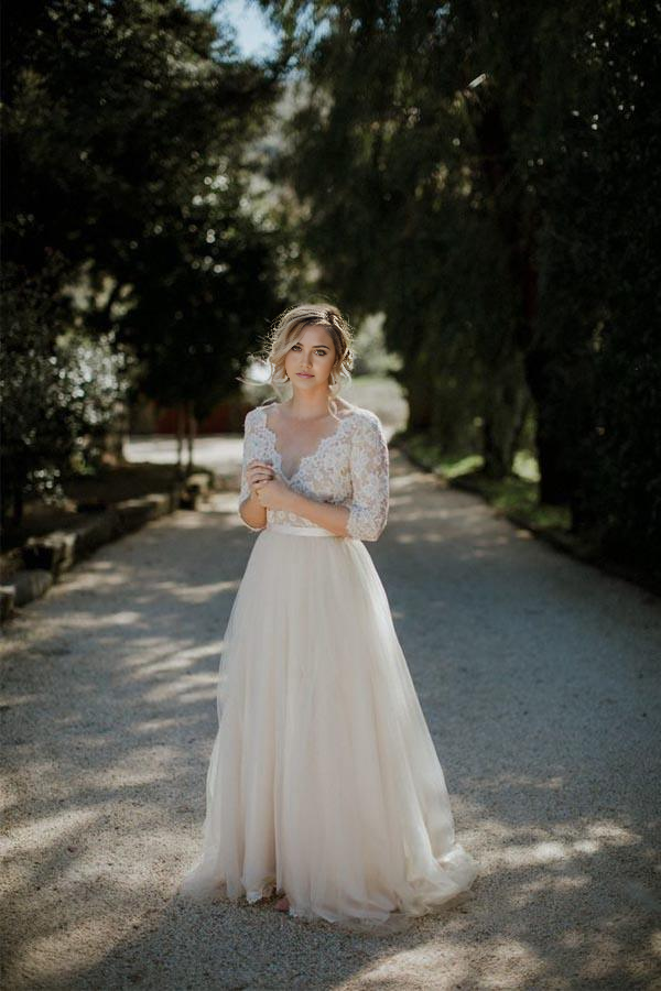 Elegant A-line V-neck half sleeve wedding dress with a belt, front view.