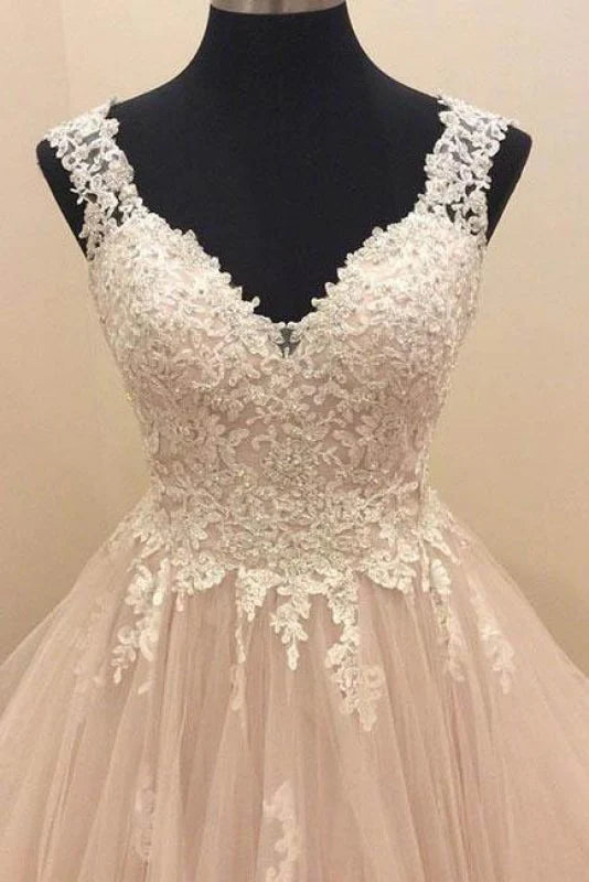 Sleeveless tulle gown with intricate lace appliques.