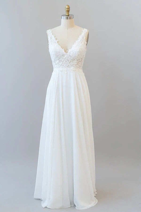 Elegant A-line V-neck wedding dress with lace appliques and flowing chiffon.