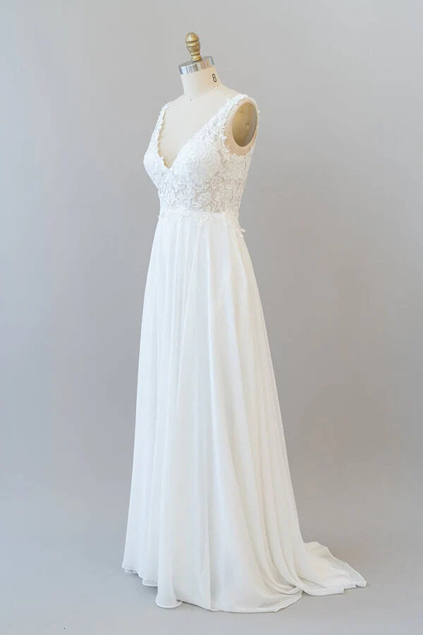 Close-up of intricate lace appliques on an A-line V-neck wedding dress.