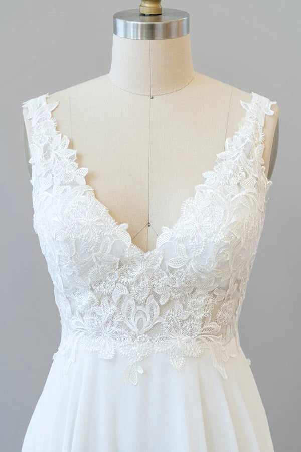 Full length view of a bride wearing an A-line V-neck chiffon wedding dress.