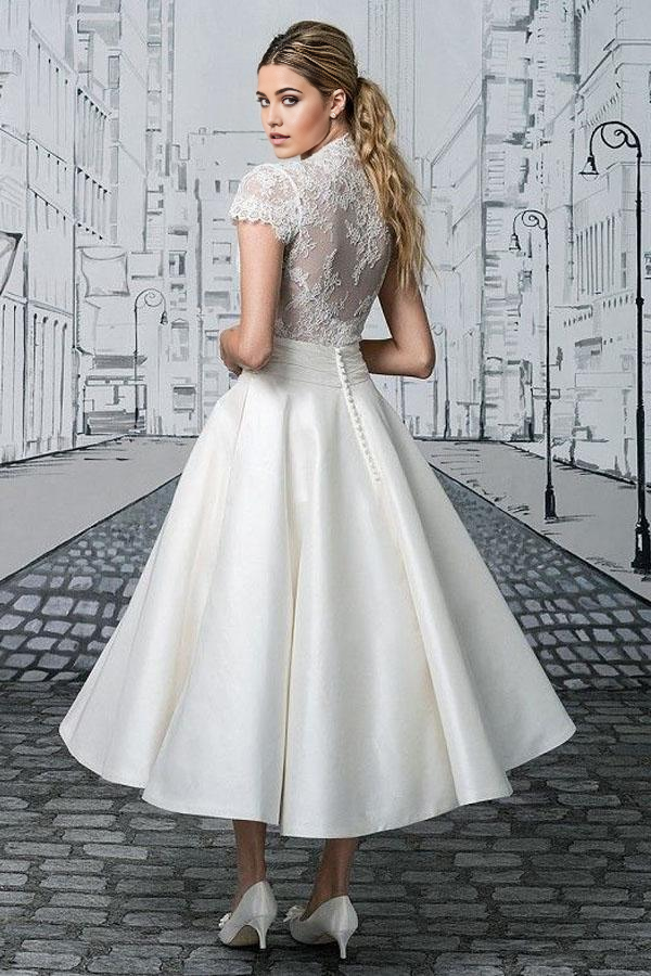 Ivory A-line V-neck lace bridal gown, side view.