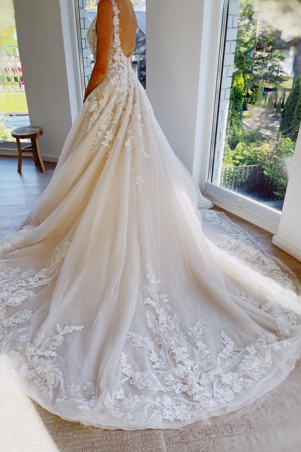 Back view of a floor-length A-line lace wedding dress.