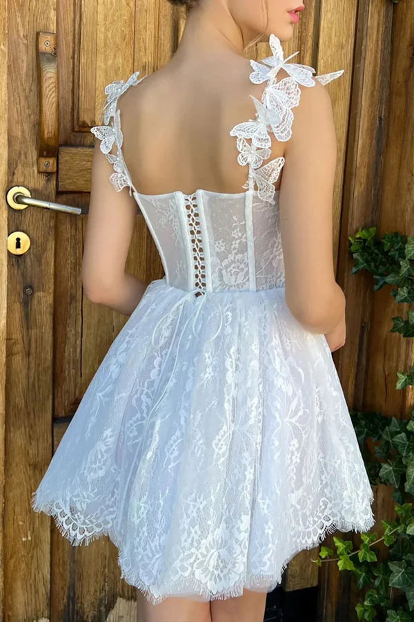 Back view of a white A-line lace short homecoming dress.