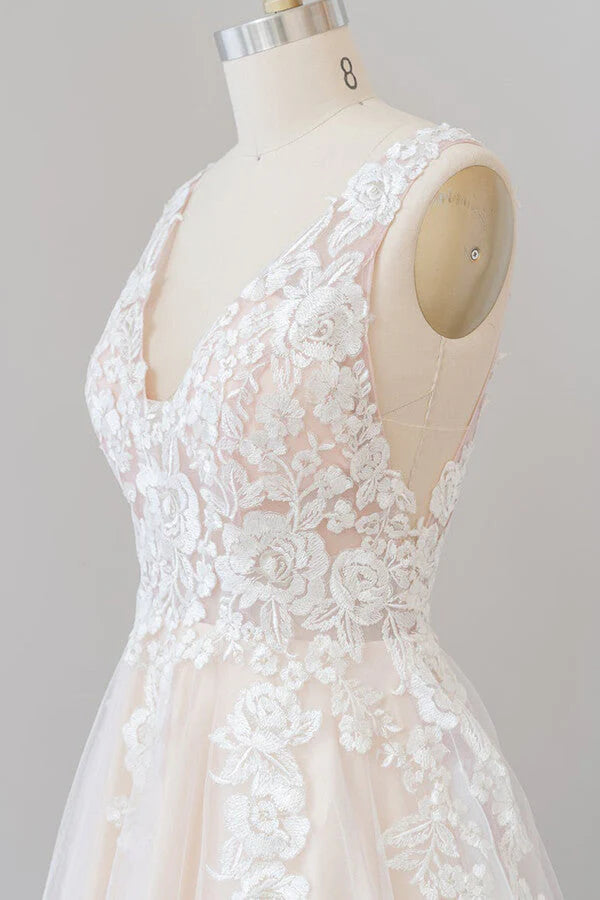 Close-up of the intricate lace appliques on the bodice of the wedding dress.