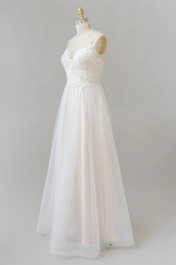 Close-up of lace appliques on V-neck wedding gown bodice.