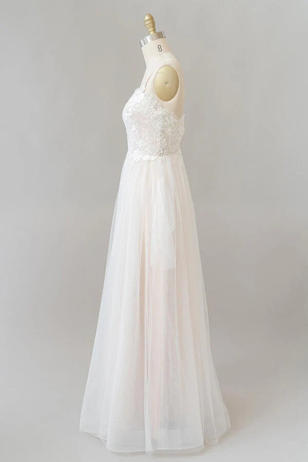 Full length view of bride wearing A-line tulle wedding dress.