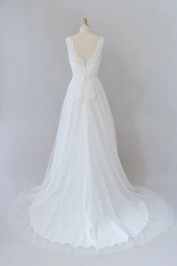 Side view of a bride wearing an A-line V-neck lace wedding gown.