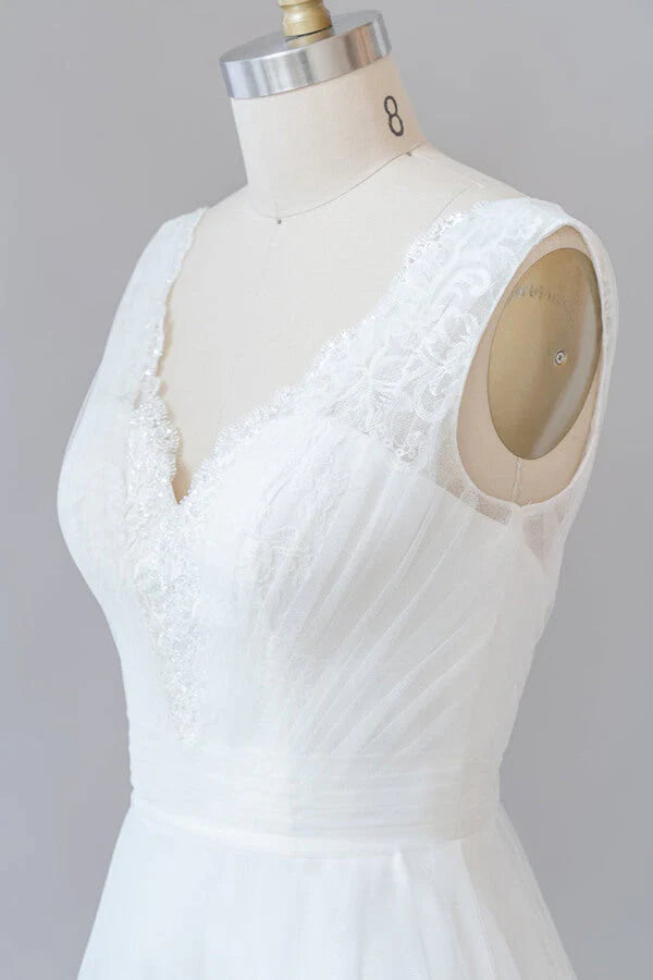 Close-up of the delicate lace and tulle fabric on a wedding dress.