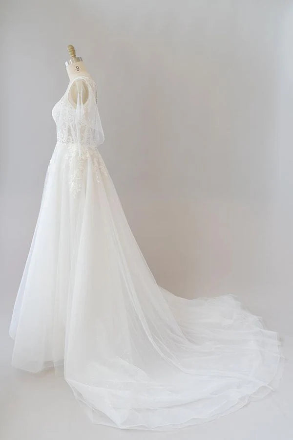 Close-up of appliques on A-line lace wedding dress.